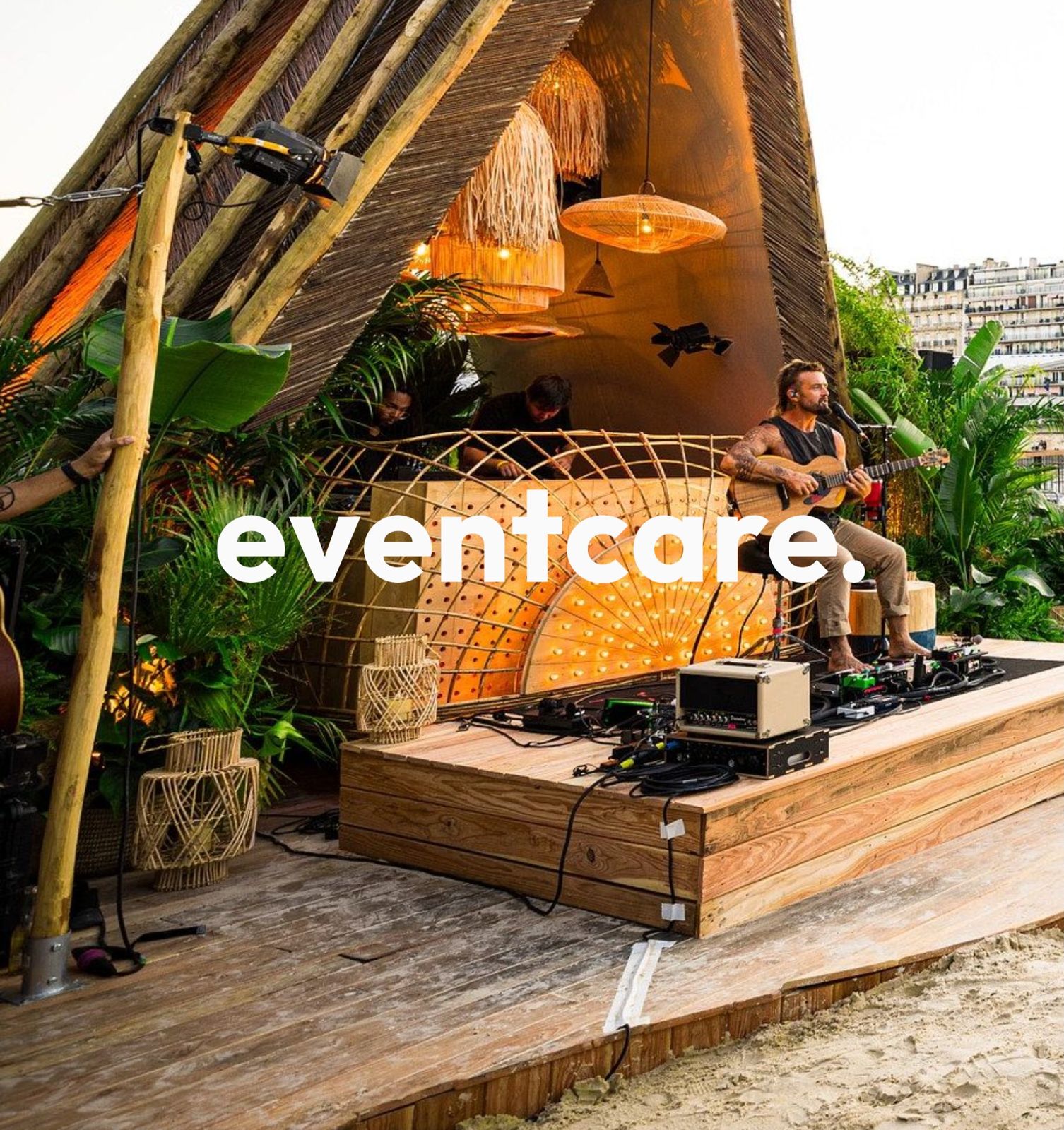 An Eventcare stage built from wood and bamboo by the water